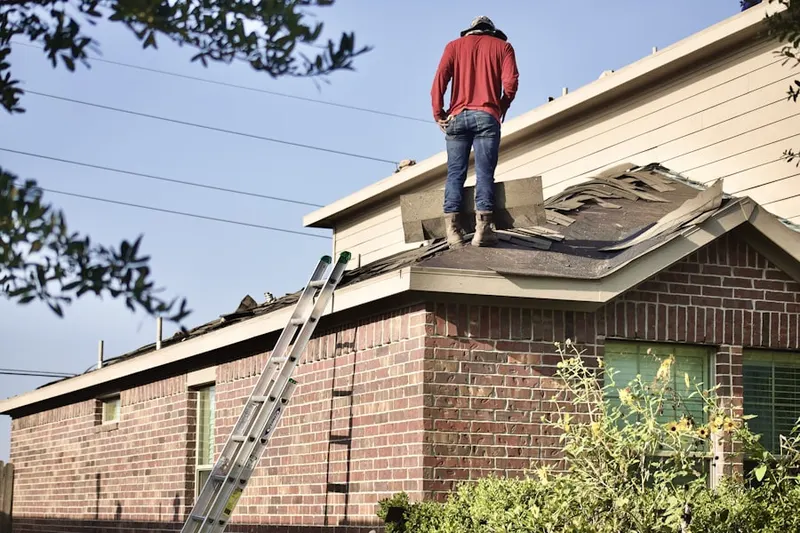 Professional roofer working on a residential roof in Chardon